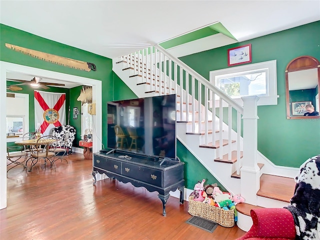 staircase with hardwood / wood-style floors