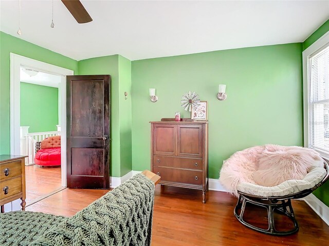 interior space with ceiling fan and wood-type flooring