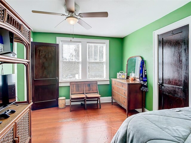 bedroom with hardwood / wood-style floors and ceiling fan