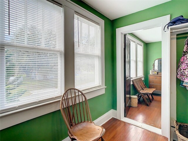 living area featuring a healthy amount of sunlight and hardwood / wood-style flooring