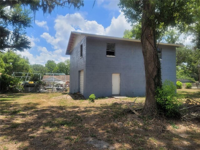 view of side of home featuring a yard