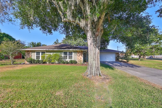 ranch-style home with a garage and a front lawn