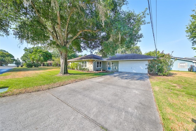 ranch-style house with a garage and a front lawn