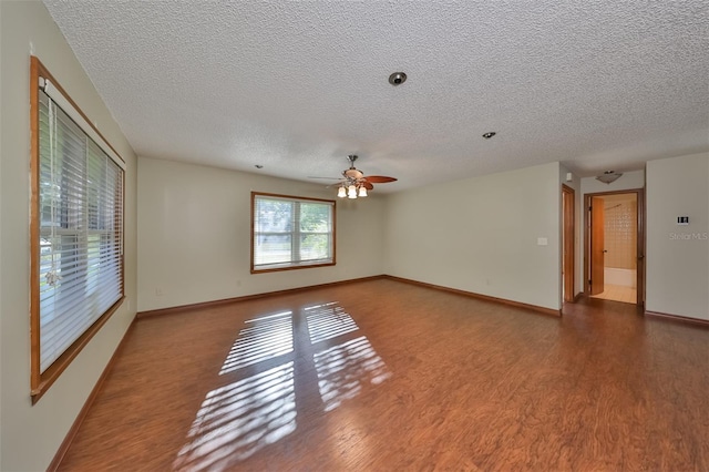 empty room featuring hardwood / wood-style floors, a textured ceiling, and ceiling fan