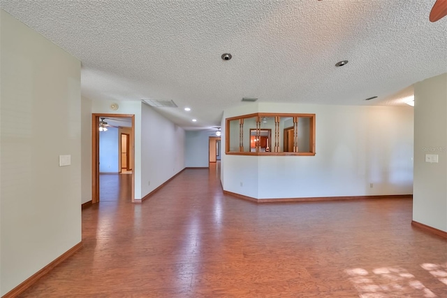 spare room with wood-type flooring, a textured ceiling, and ceiling fan