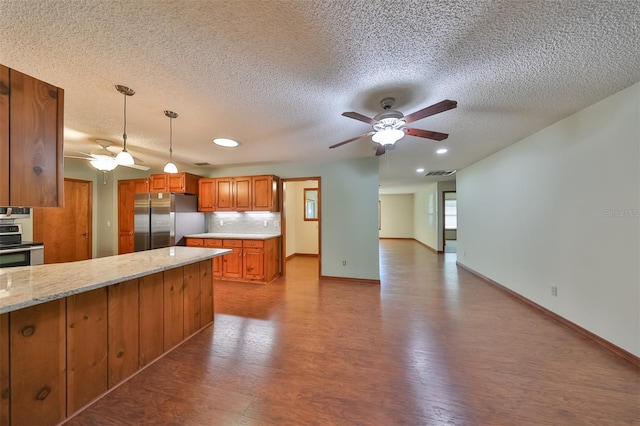 kitchen with ceiling fan, backsplash, hanging light fixtures, and appliances with stainless steel finishes