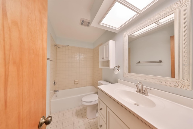 full bathroom with vanity, toilet, tiled shower / bath, and tile patterned flooring