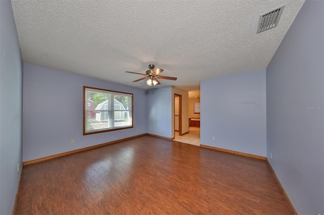 unfurnished room with light hardwood / wood-style floors, a textured ceiling, and ceiling fan