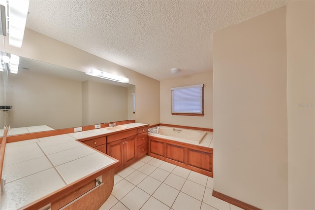 bathroom featuring a tub, a textured ceiling, tile patterned flooring, and vanity