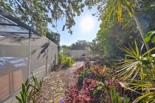 view of yard featuring glass enclosure