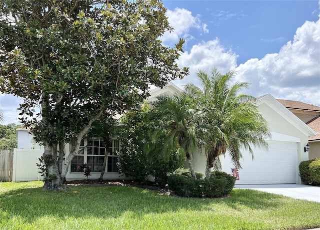 view of front facade with a garage and a front lawn