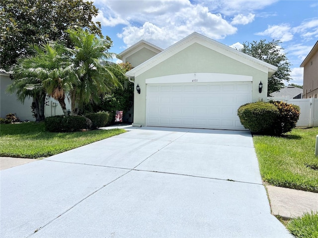 view of front of home featuring a front yard and a garage