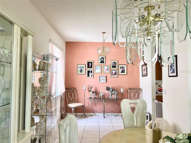 tiled dining room featuring a textured ceiling and a notable chandelier