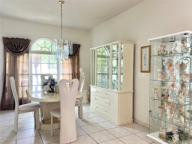 dining room with plenty of natural light, light tile patterned floors, and an inviting chandelier