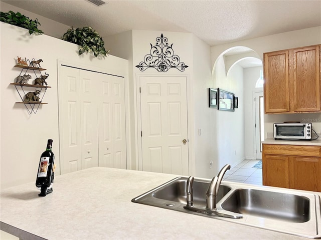 kitchen with sink and a textured ceiling