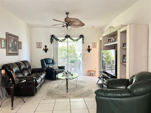 tiled living room with a textured ceiling and ceiling fan