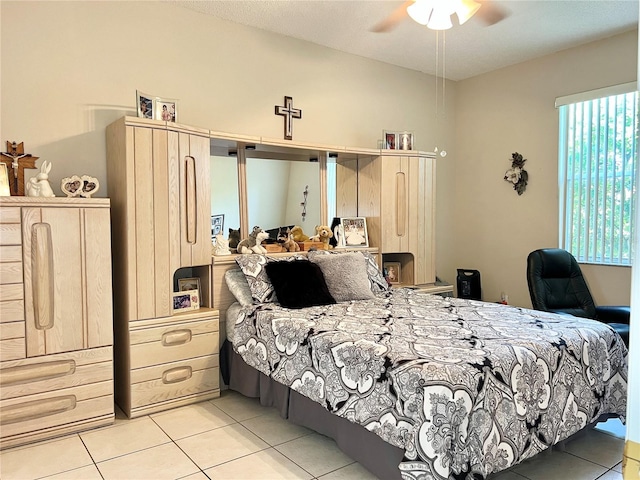 tiled bedroom with ceiling fan