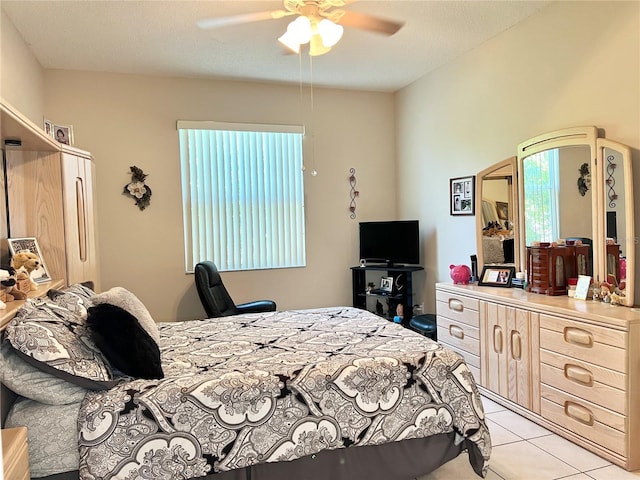 bedroom with light tile patterned floors and ceiling fan