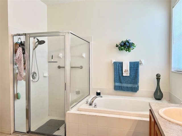 bathroom featuring vanity and independent shower and bath