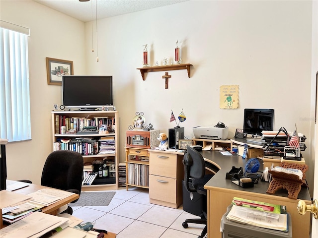 office with light tile patterned floors and a textured ceiling