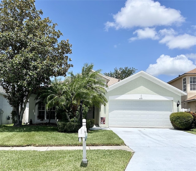 view of front of house featuring a garage and a front lawn