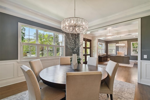 dining area featuring ornamental molding, an inviting chandelier, and dark hardwood / wood-style flooring