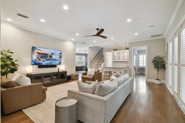 living room with ornamental molding, ceiling fan, and hardwood / wood-style floors