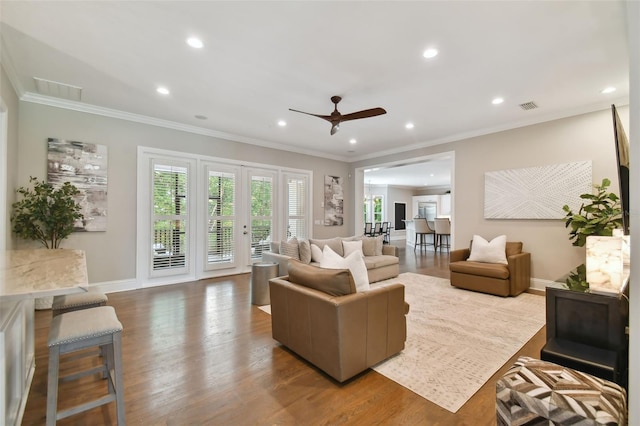 living room featuring ceiling fan, crown molding, and hardwood / wood-style flooring