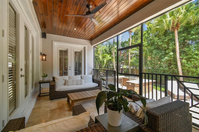 sunroom with ceiling fan, french doors, and wood ceiling