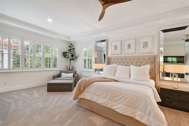 bedroom with light colored carpet, ornamental molding, ceiling fan, and a tray ceiling