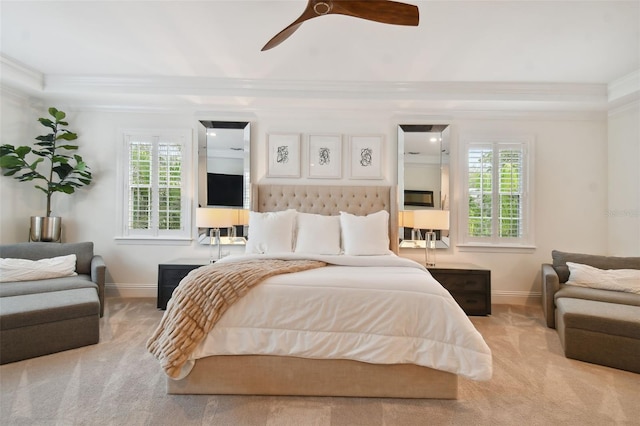 carpeted bedroom with ceiling fan, crown molding, and multiple windows