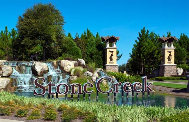 community / neighborhood sign featuring a water view