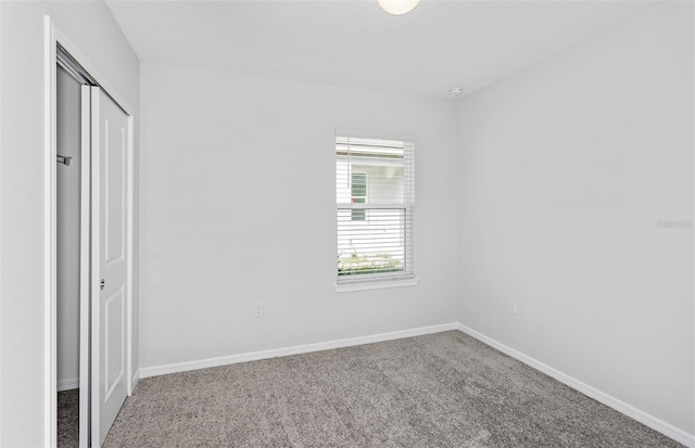 unfurnished bedroom featuring a closet and carpet floors