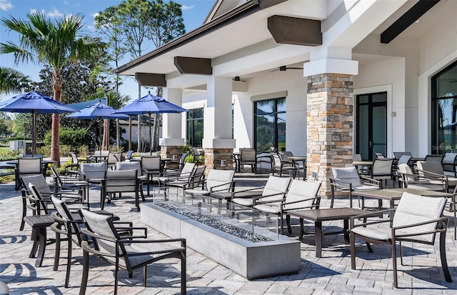 view of patio / terrace with ceiling fan and an outdoor fire pit