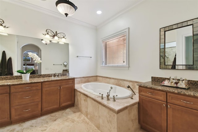 bathroom featuring tiled tub, crown molding, tile patterned flooring, and vanity