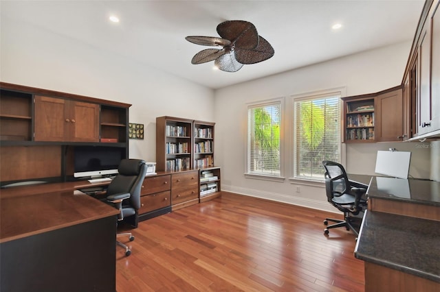 home office featuring dark wood-type flooring and ceiling fan