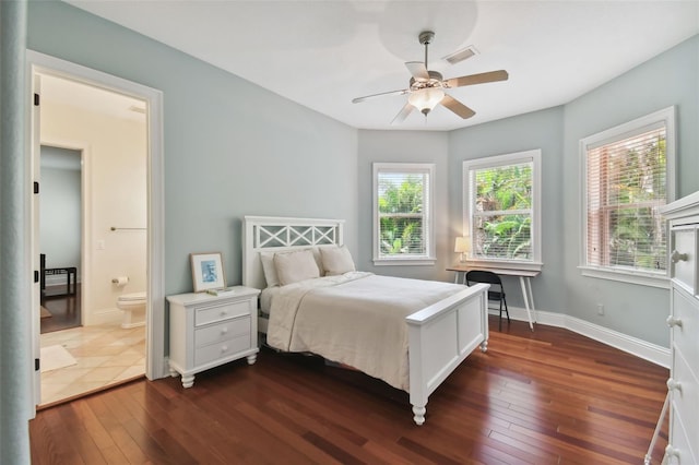 bedroom featuring connected bathroom, dark wood-type flooring, and ceiling fan