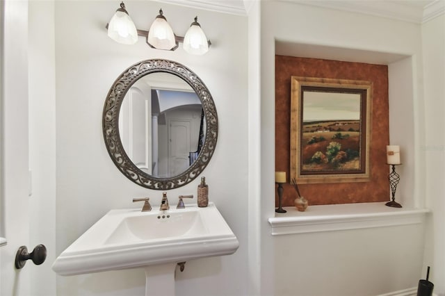 bathroom featuring crown molding and sink