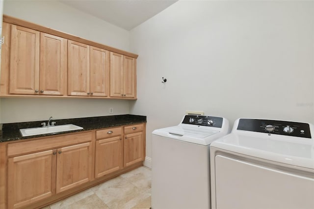 washroom featuring cabinets, independent washer and dryer, light tile patterned flooring, and sink