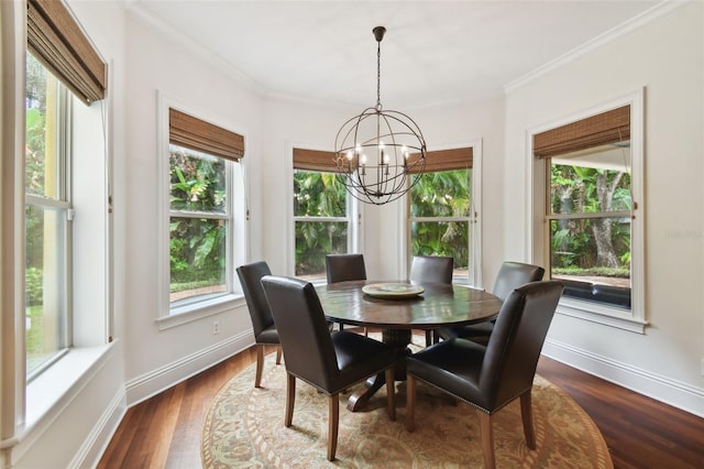 dining area featuring ornamental molding, an inviting chandelier, and dark hardwood / wood-style flooring