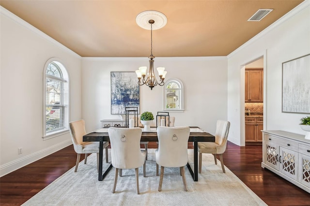 dining area featuring dark wood-type flooring, visible vents, plenty of natural light, and a notable chandelier