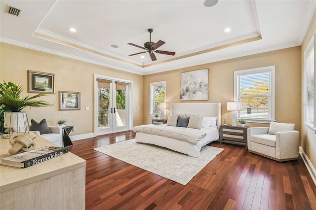 bedroom with access to outside, a tray ceiling, multiple windows, and french doors