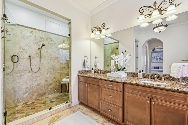 ensuite bathroom featuring ornamental molding, a sink, and ensuite bathroom