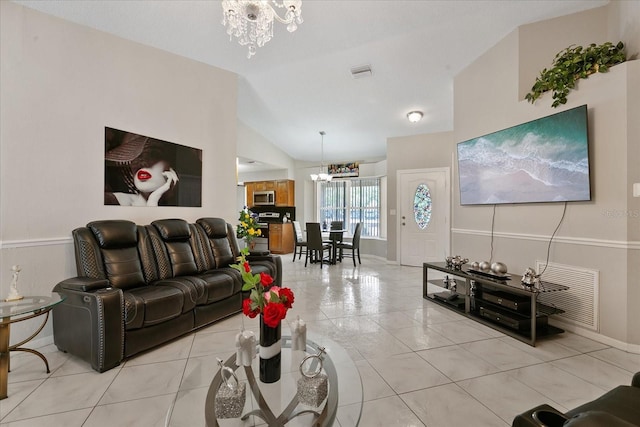 living room with a notable chandelier and lofted ceiling