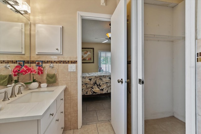 bathroom featuring tile patterned floors, ceiling fan, and vanity