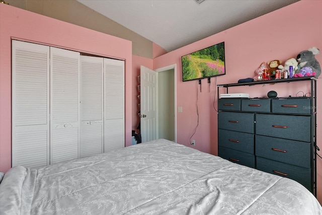 bedroom featuring a closet and lofted ceiling