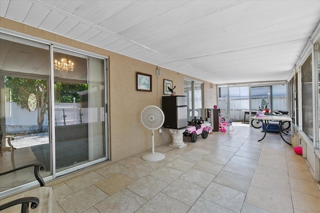 sunroom with a chandelier