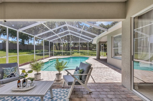 view of pool with a lanai, a patio area, and a yard