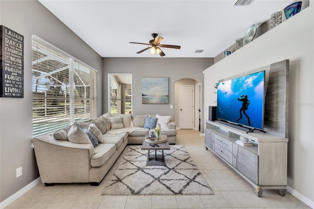805 Woodcarver Ln, Brandon, FL 33510 - living room featuring arched walkways, ceiling fan, and light tile patterned floors