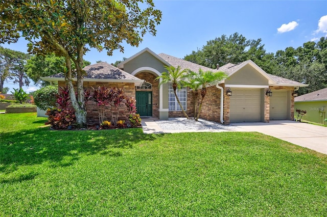 805 Woodcarver Ln, Brandon, FL 33510 - ranch-style house with an attached garage, a front yard, driveway, and stone siding